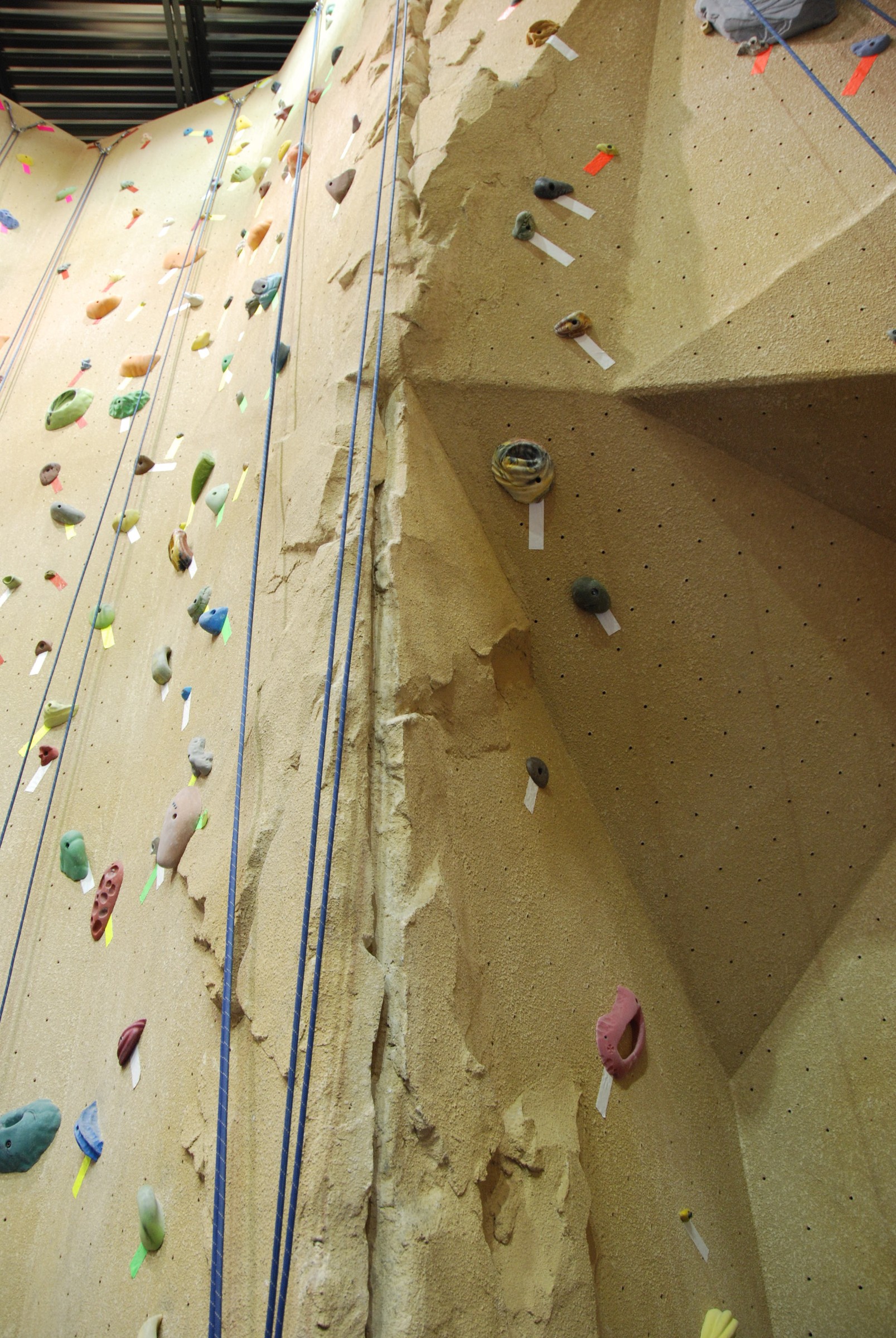 Tall climbing wall with StoneCraft rock texture and coloured holds