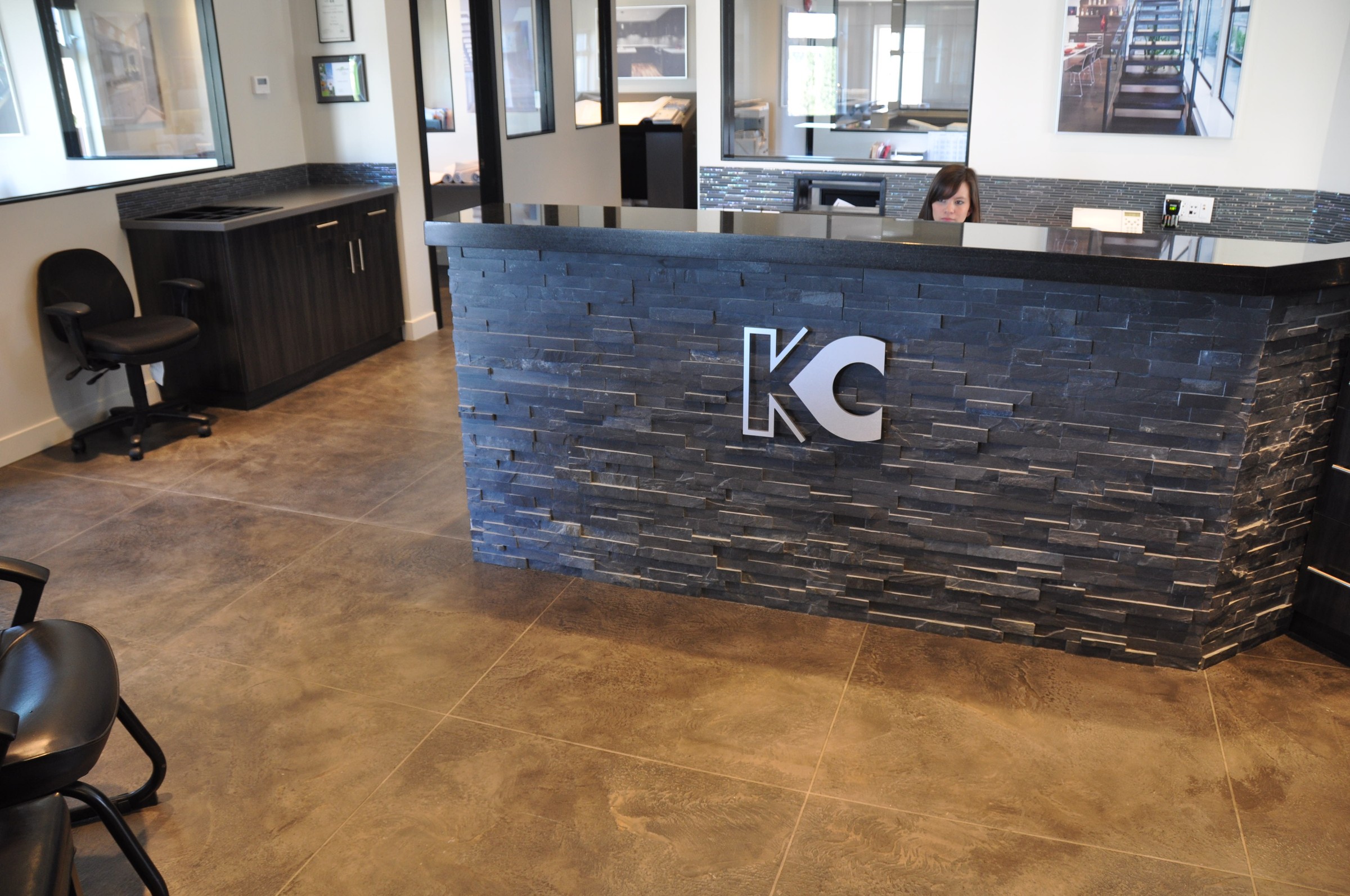Modern StoneCraft floor in a corporate office reception area with stone desk