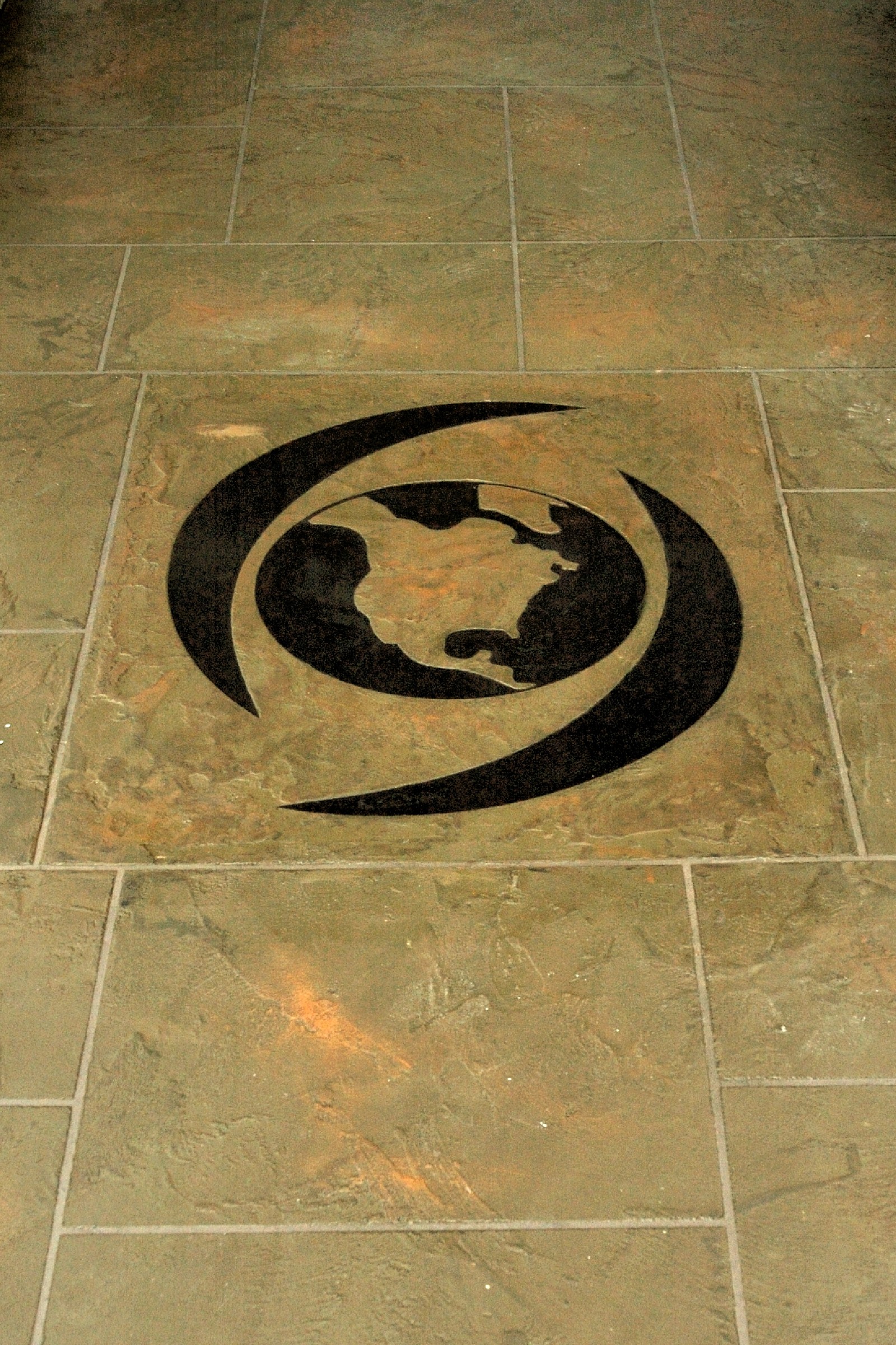 Custom globe logo design integrated into StoneCraft commercial floor