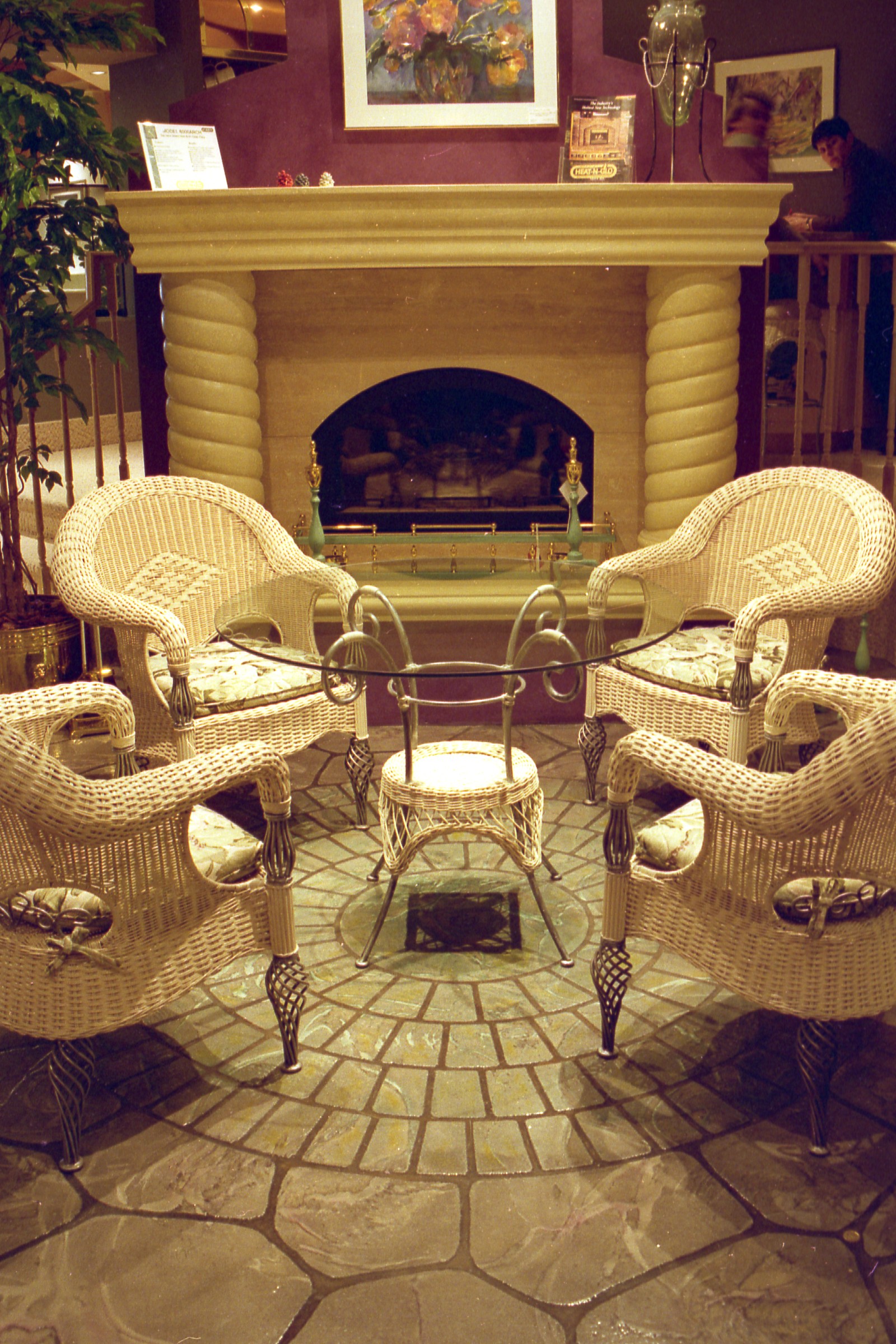 Traditional StoneCraft fireplace surround with arched opening and decorative columns