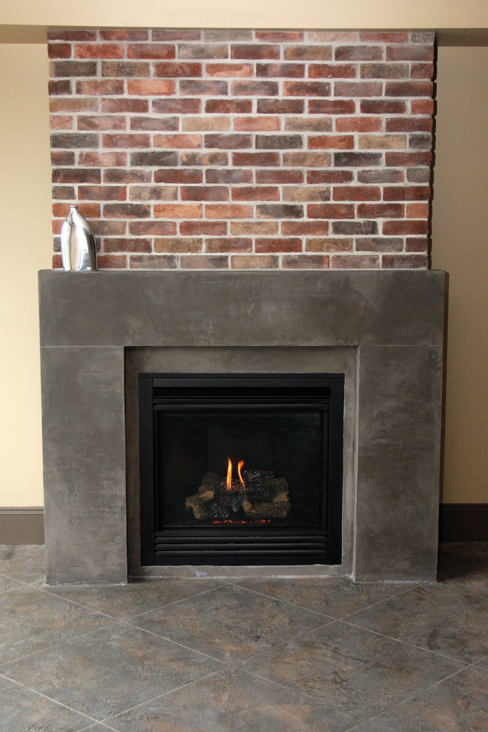 Heat-resistant StoneCraft fireplace surround with lit gas fire