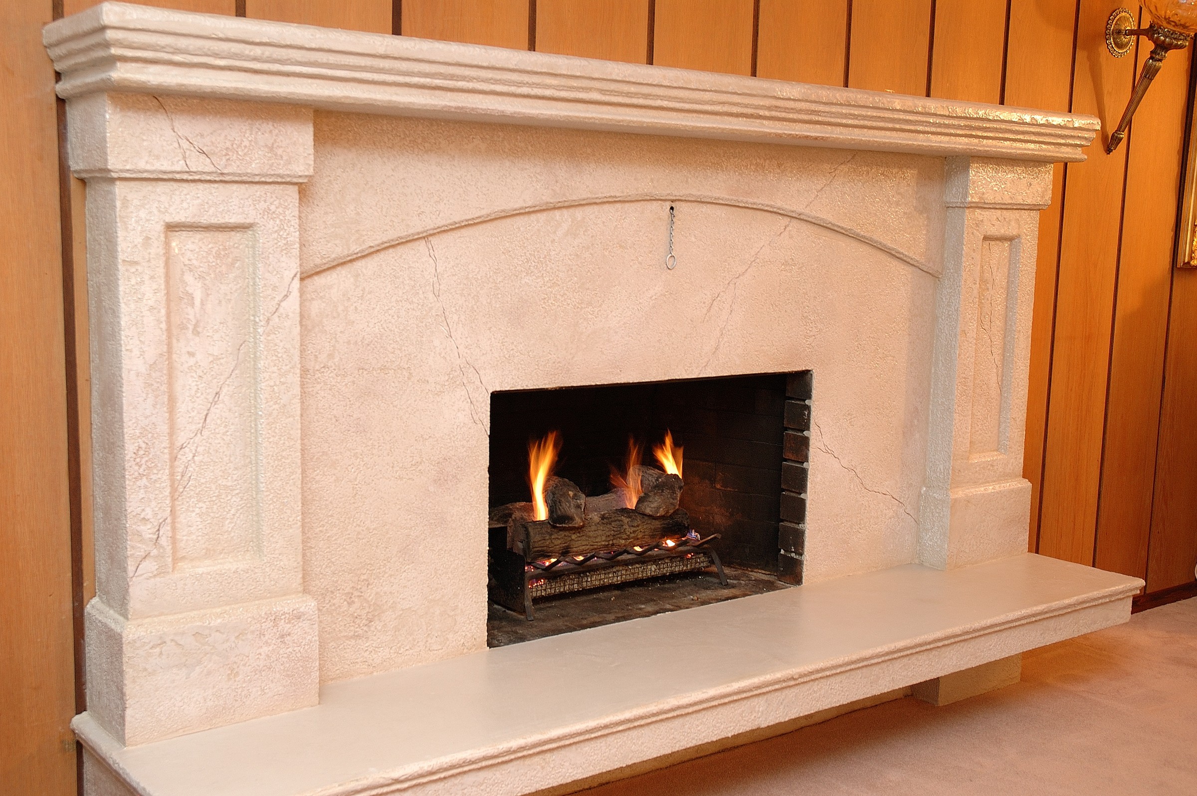 Contemporary dark grey StoneCraft surround with TV and fireplace