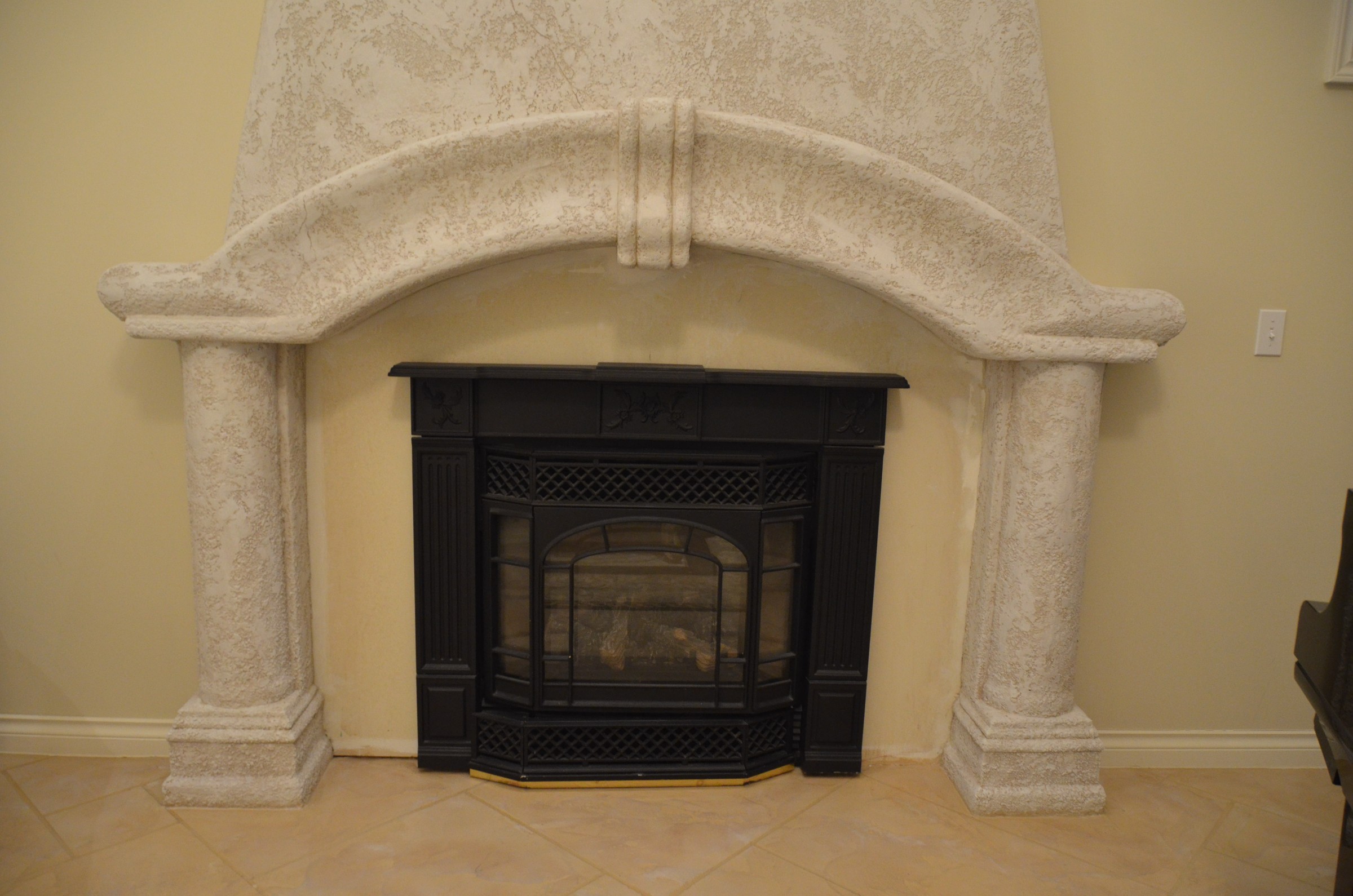Arched fireplace mantel with cream textured StoneCraft surround