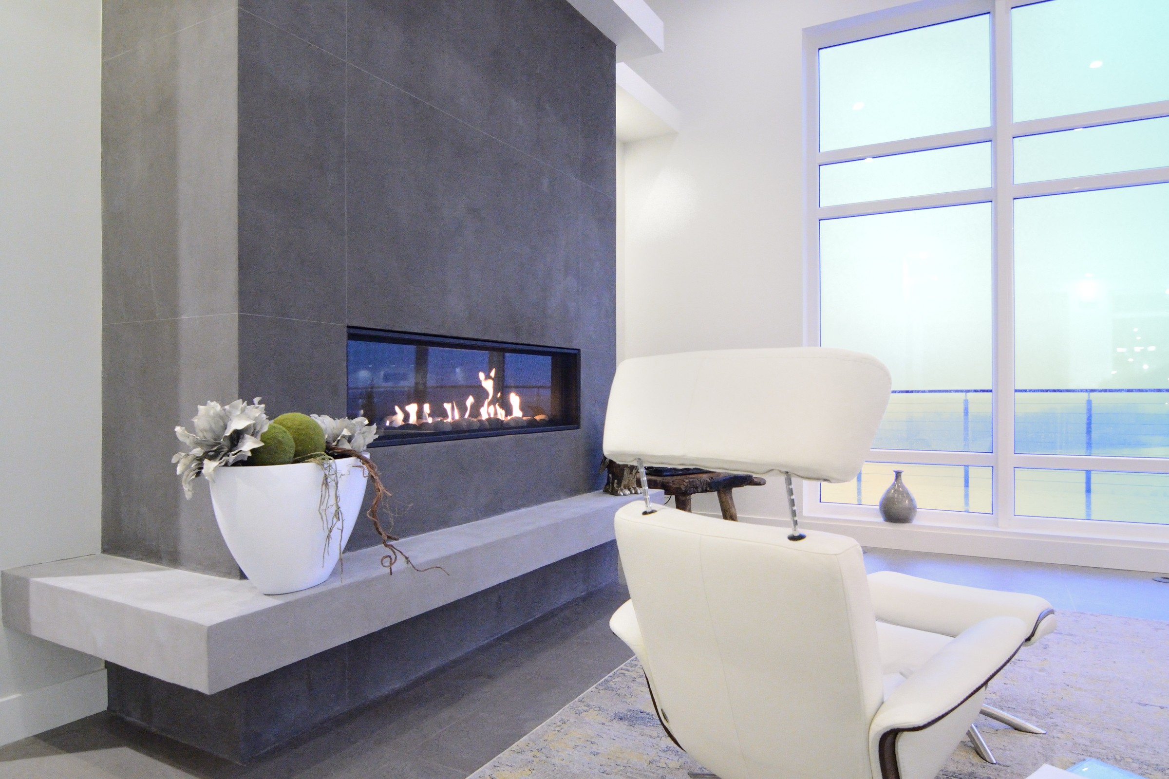 Dark grey contemporary StoneCraft surround with fireplace and TV mount