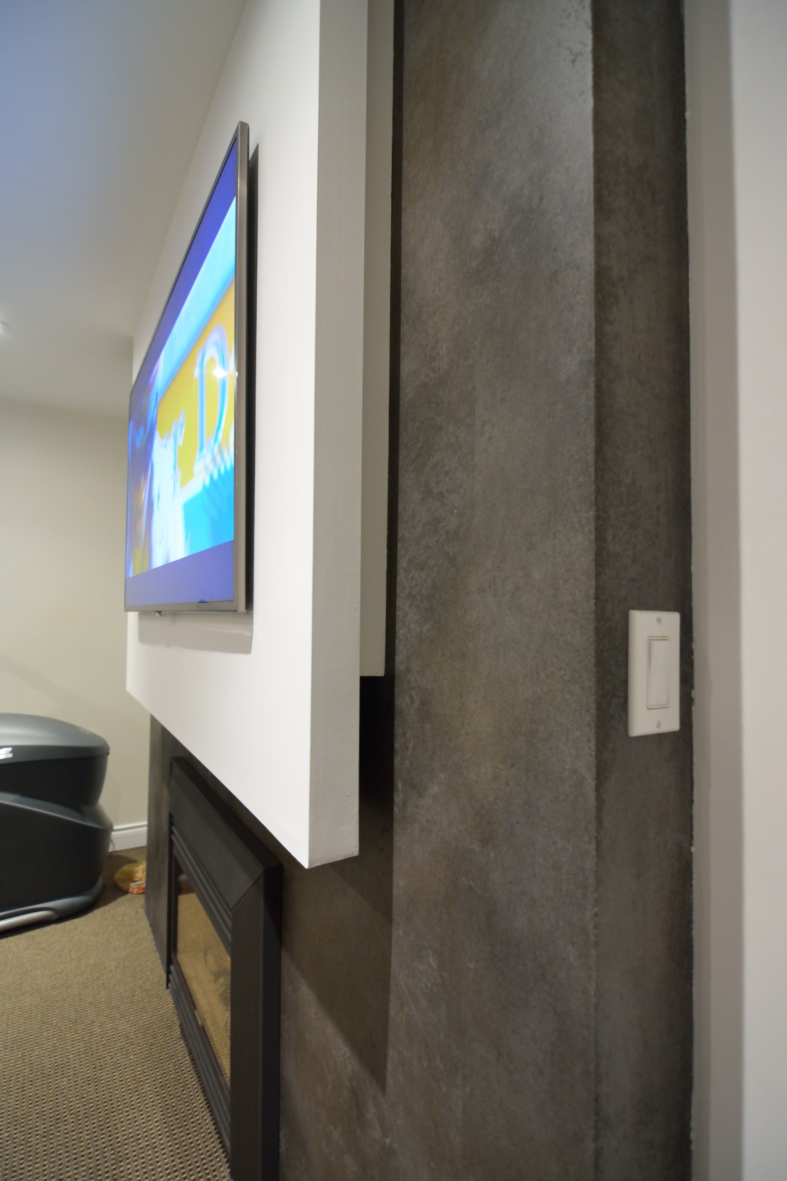 Beige marble-finish StoneCraft surround with decorative columns and arched mantel