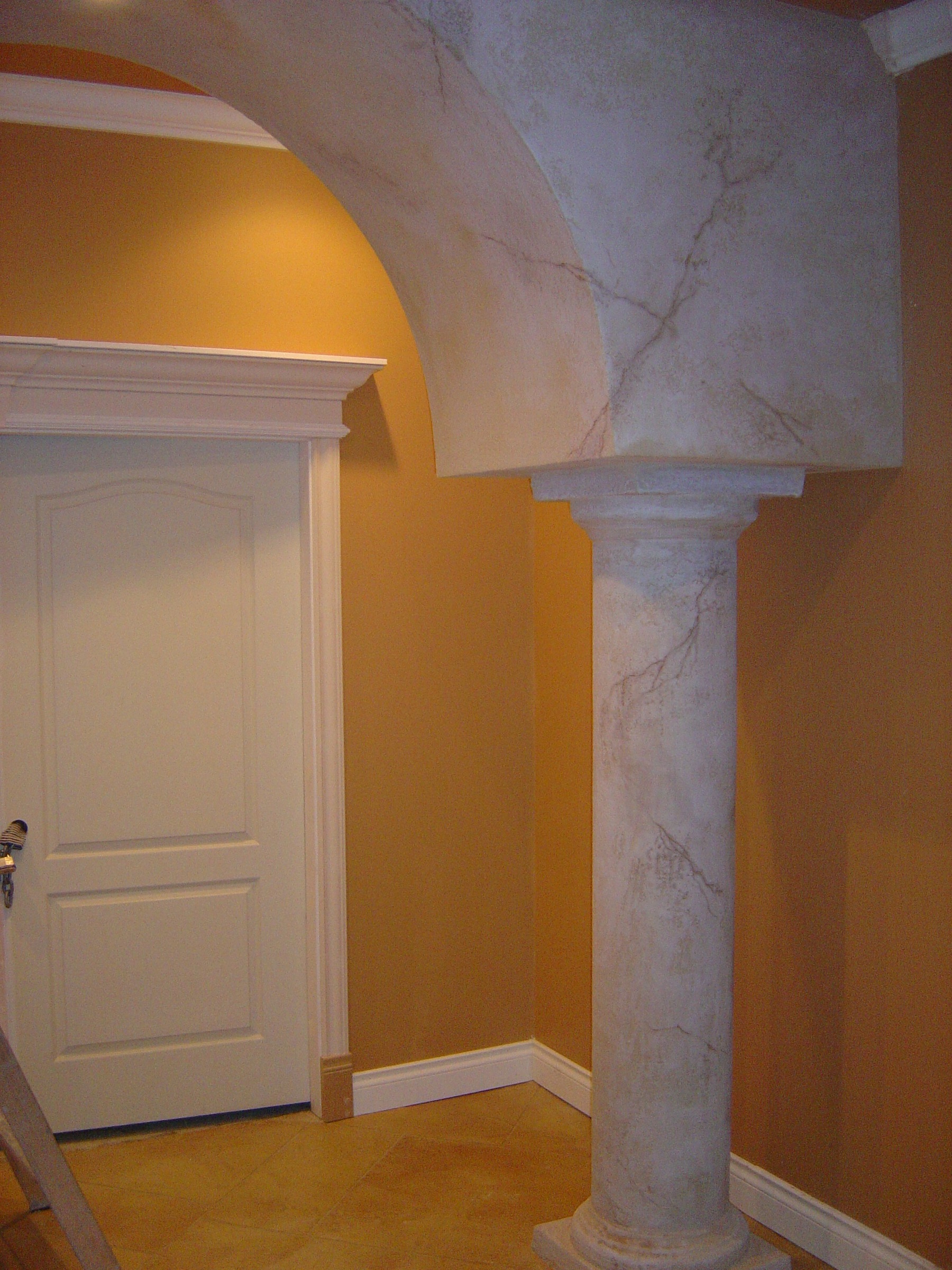 Traditional cream StoneCraft mantel with columns and fireplace insert