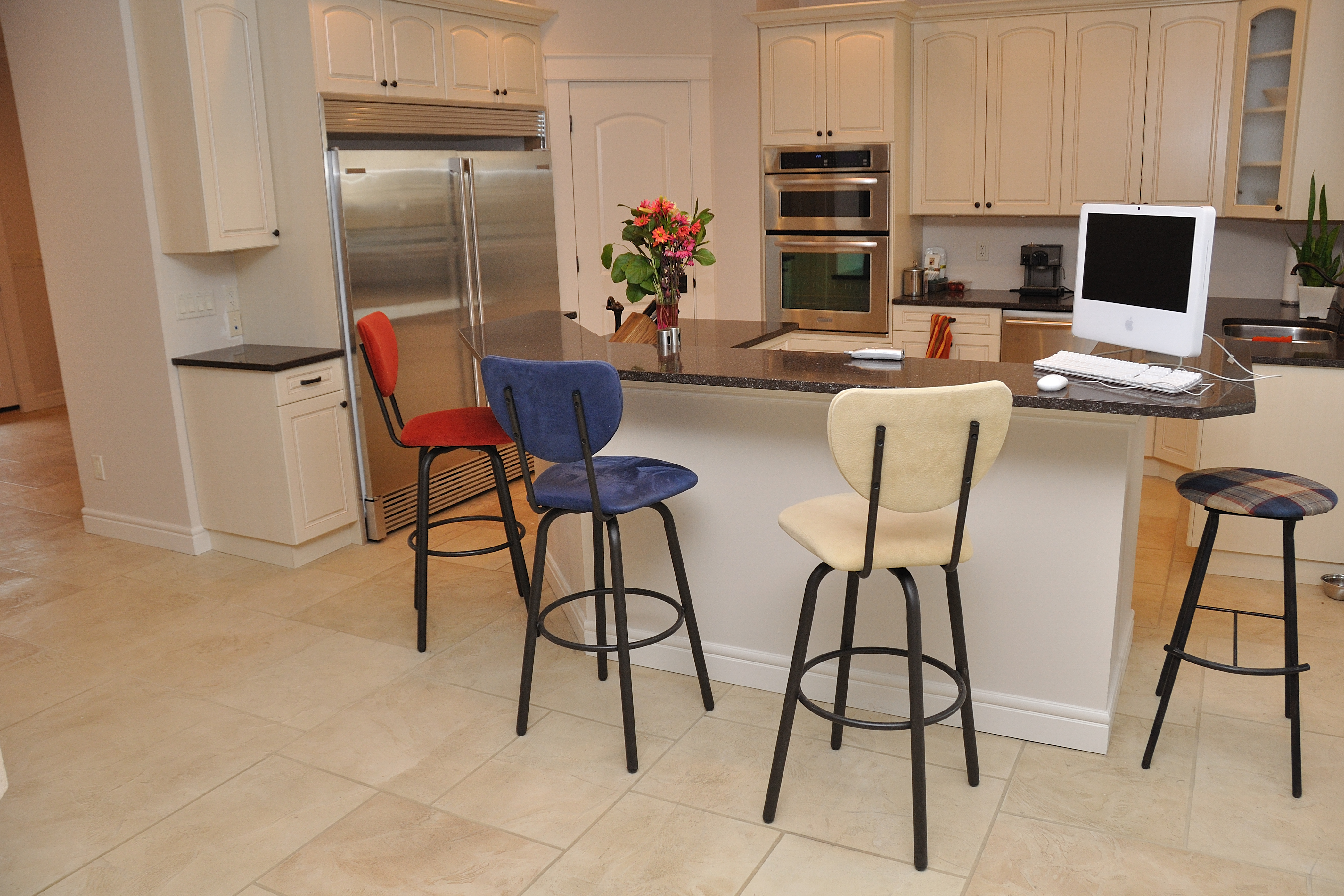 Kitchen with warm sandstone StoneCraft flooring and oak cabinetry