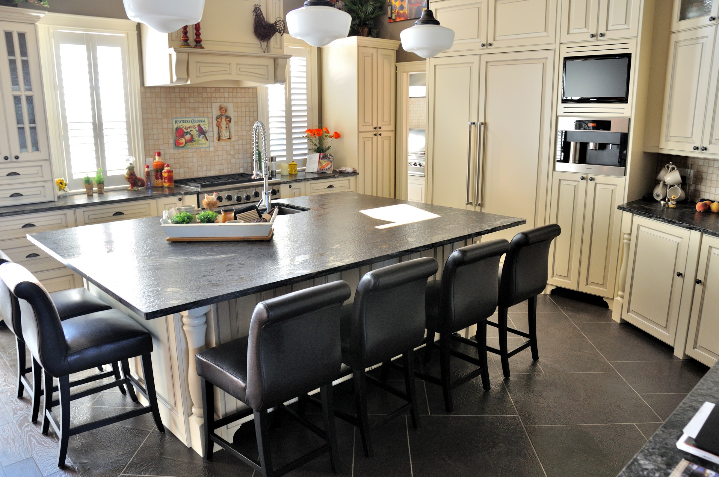 Modern kitchen with dark charcoal StoneCraft flooring and white cabinetry