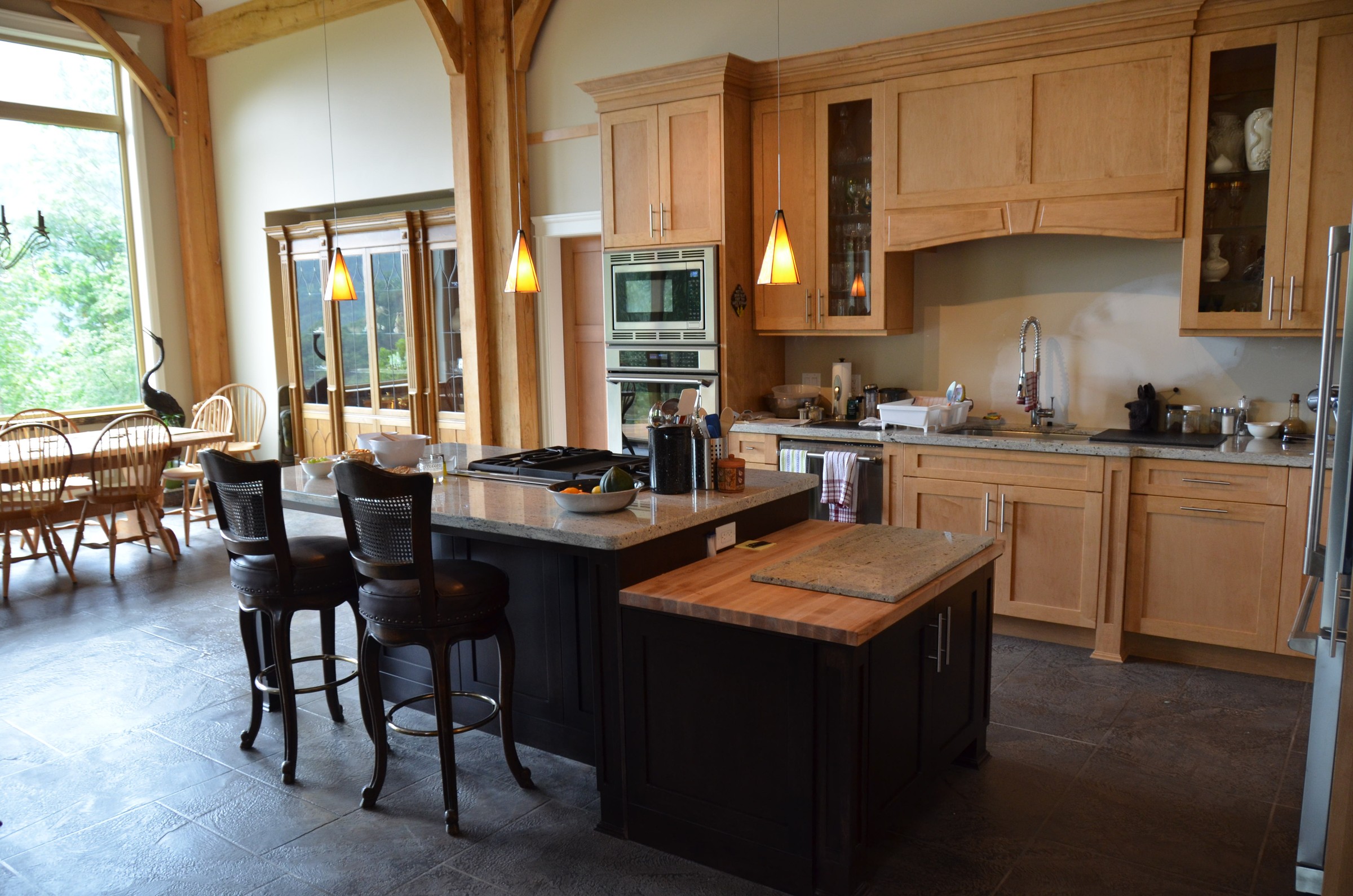 Warm StoneCraft kitchen floor in timber-frame home