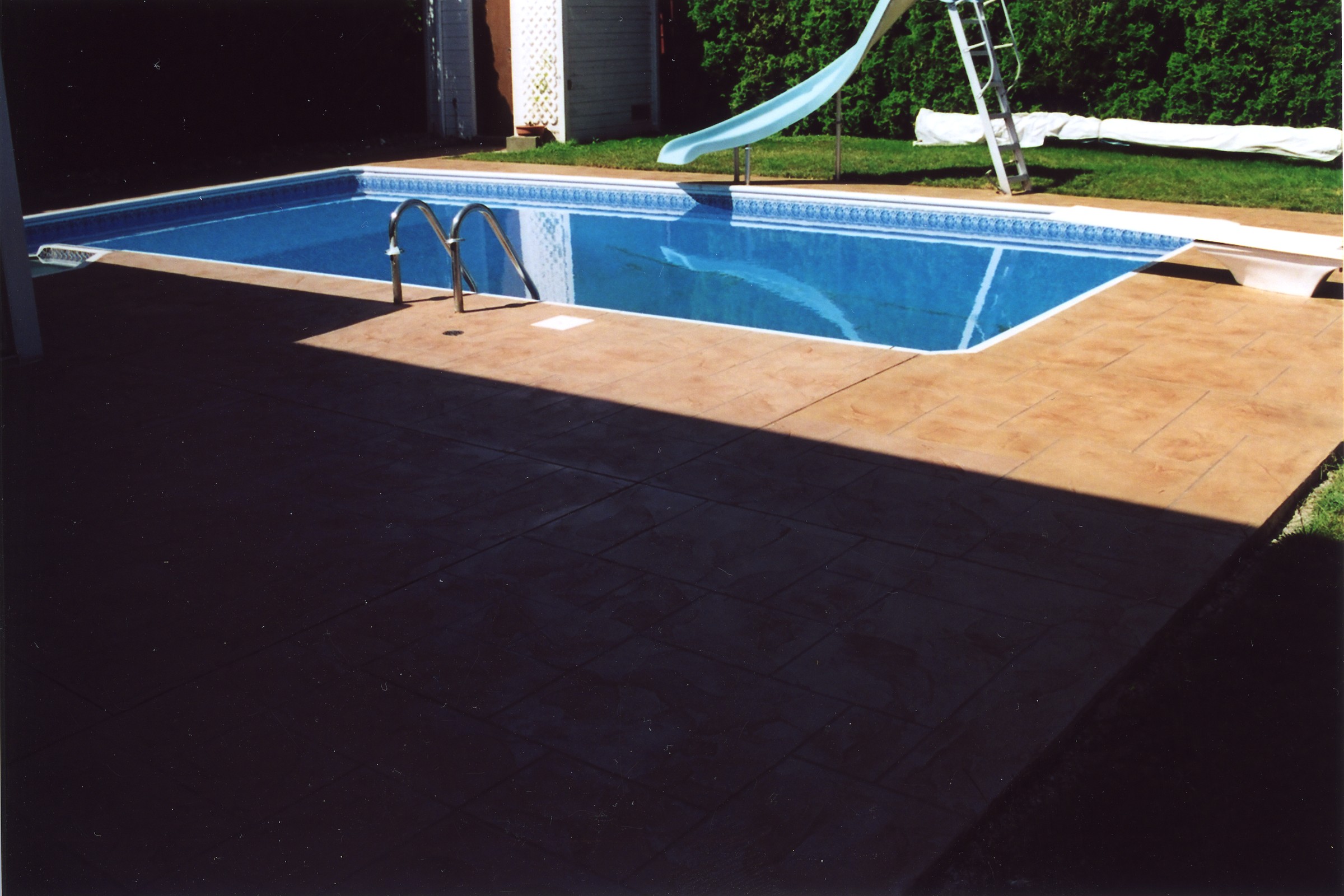 Two-tone pool deck with charcoal and terracotta StoneCraft surfacing