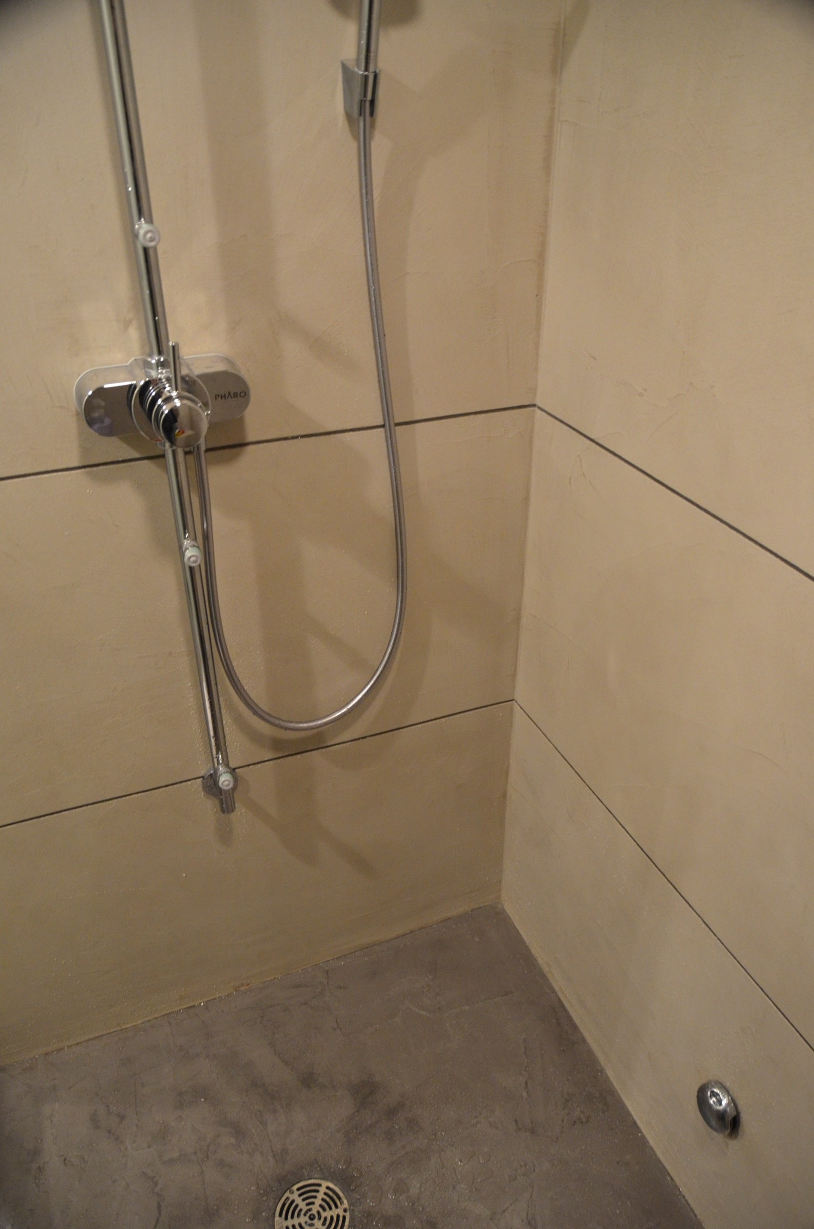 Walk-in shower with cream StoneCraft wall panels and floor